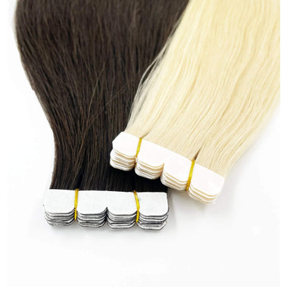 Close-up view of two sets of Image London Hair Extensions, one dark brown and one light blonde, each with white adhesive strips at the top for application. The extensions are neatly aligned and secured with gold elastic bands, a testament to expert hair extension maintenance.